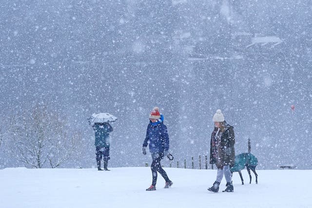 <p>People walking in snowy conditions in Crow Park, Keswick in Cumbria</p>